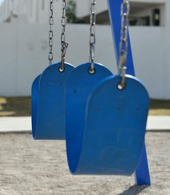 blue-swings-in-playground blue-swings-in-playground