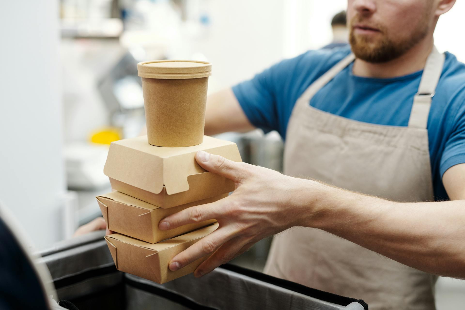 A man holding takeaway cardboards