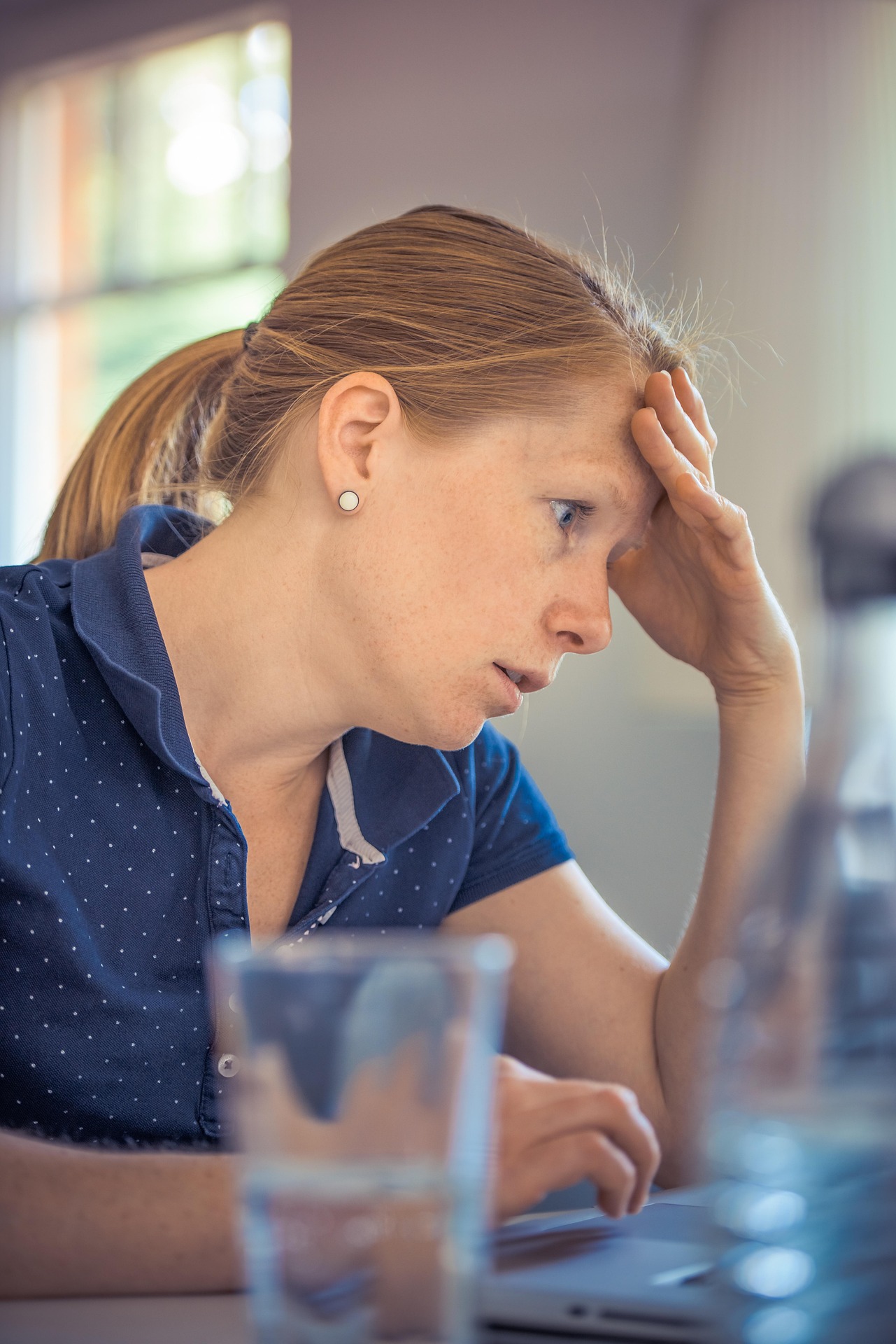 Annoyed adult woman dealing with an insurance claim Annoyed adult woman dealing with an insurance claim